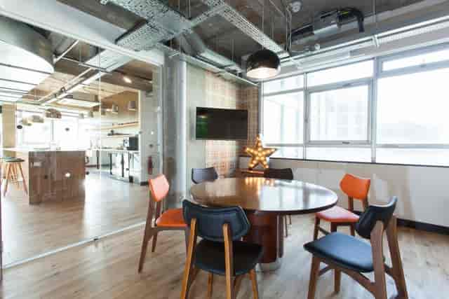 Modern meeting space with round table and natural light at The Trampery Old Street.