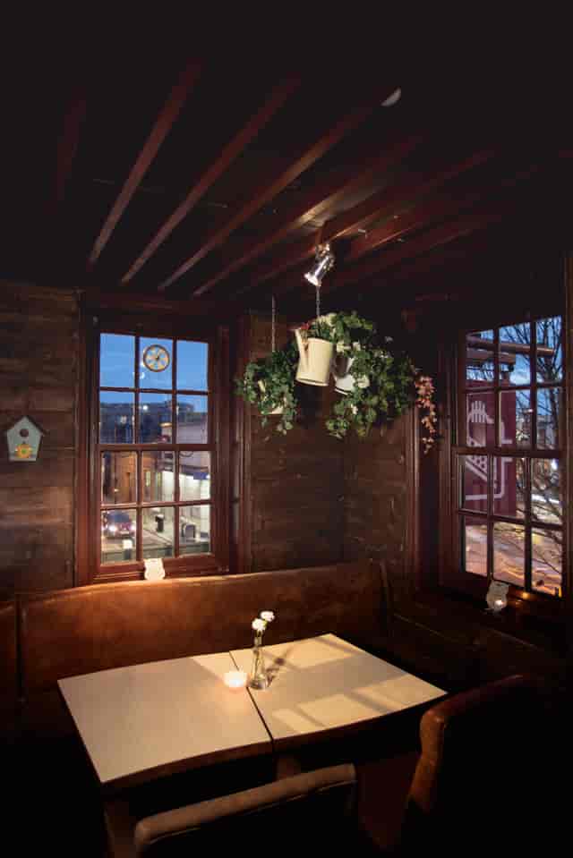 Cozy rustic venue with wooden walls for intimate gatherings and workshops.