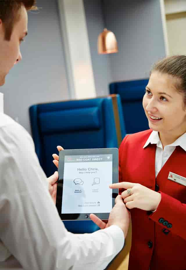 Event staff using tablet in Studio 1, London Marriott Hotel Kensington for efficient management.