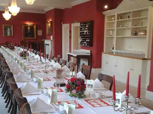 Elegant dining table with floral centerpieces in St Pauls Club for formal events.