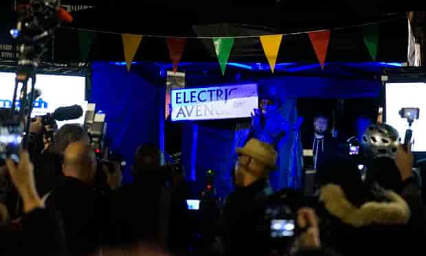 Event Space in Electric Avenue with vibrant stage, engaging crowd at outdoor festival.