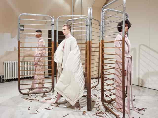 Avant-garde fashion presentation at The River Rooms, Somerset House, minimalist backdrop.