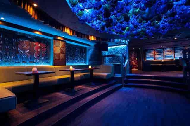 Stylish Mahiki London venue with blue lighting, ideal for cocktail receptions and networking.