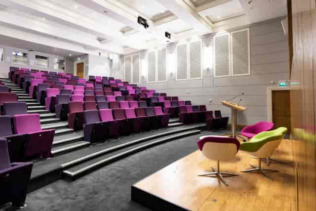 Henry Wellcome Auditorium with tiered purple seating for conferences and events.