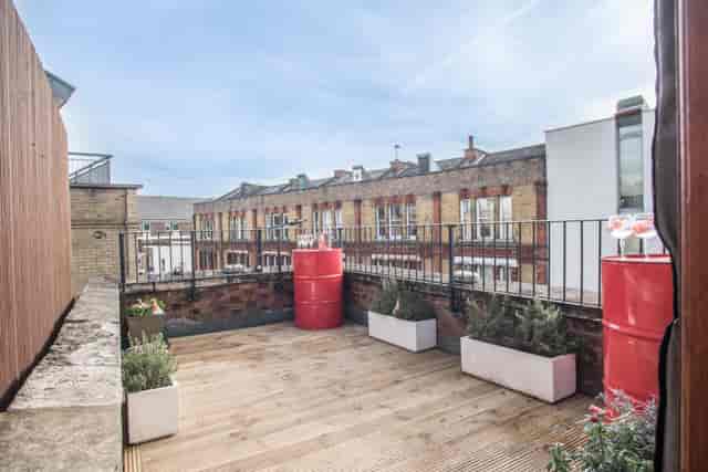 Private dining room terrace with wooden flooring for casual meetings and networking events.