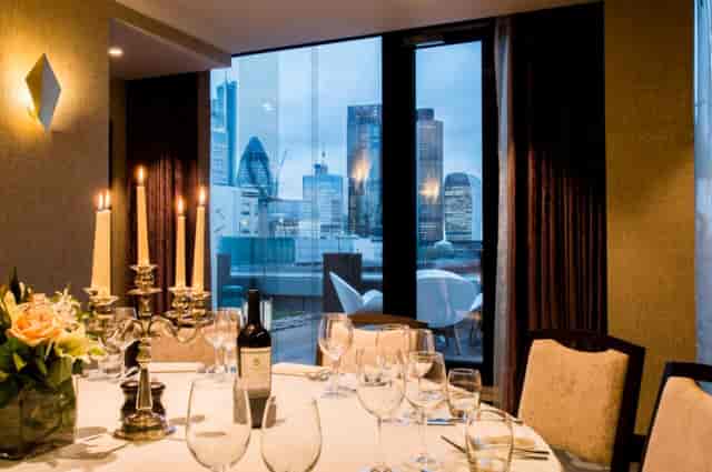 Elegant dining table with candlelight in Palm Rooms, perfect for upscale corporate events.