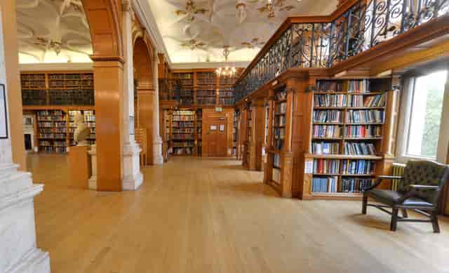 Elegant library with warm wood tones, perfect for intimate meetings and workshops.