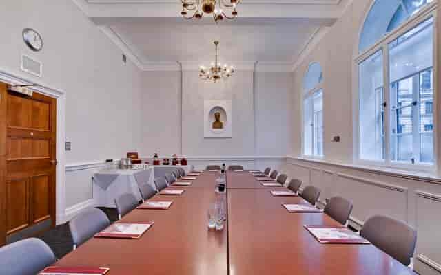 "Elegant meeting room with long table, ideal for professional events and discussions."
