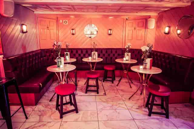 Stylish Function Room at Simmons, Liverpool Street with plush red seating for events.