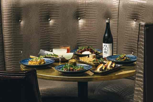 Elegant dining table with gourmet dishes at Karma Sanctum Soho for upscale events.