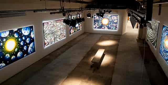Spacious gallery with vibrant art, ideal for creative events and exhibitions.