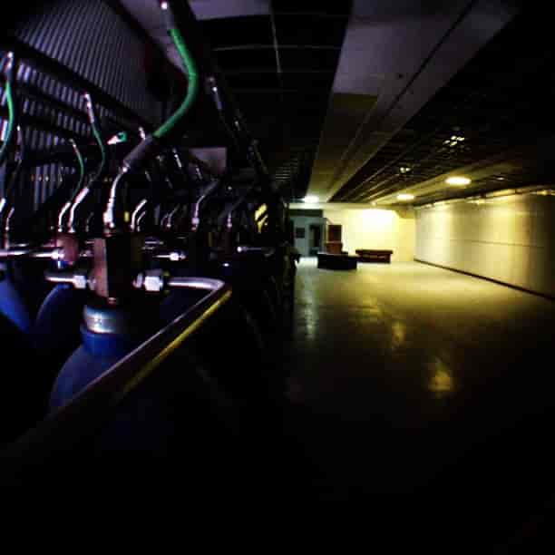 Spacious industrial venue with gas cylinders for unique events and immersive experiences.