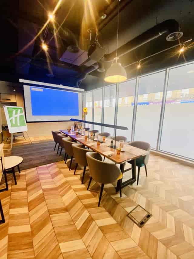 Whitechapel Think Factory meeting room with wooden table, ideal for corporate events.