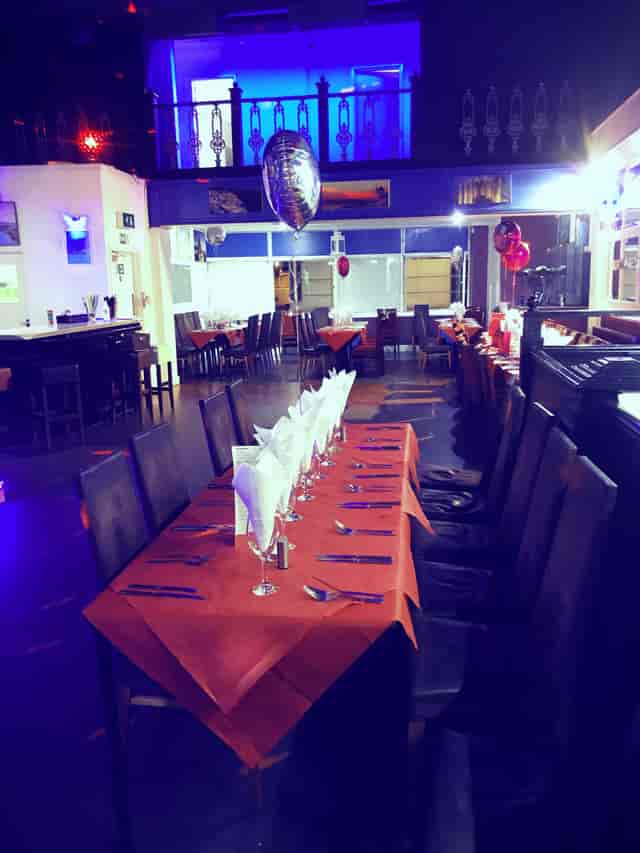 Whole Venue in Santorini Restaurant with orange tablecloths for events and celebrations.
