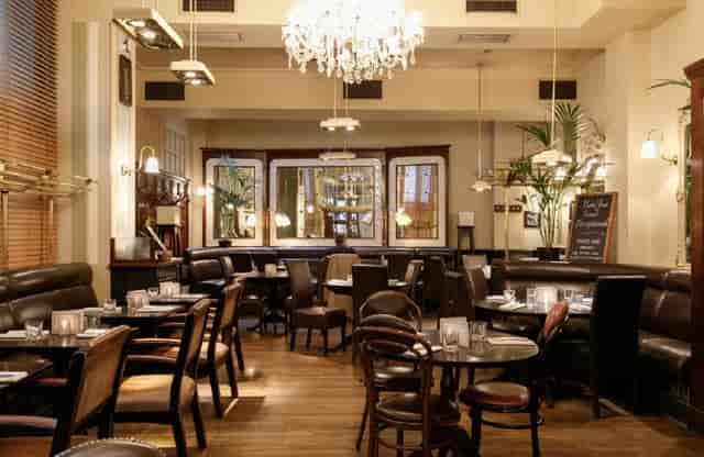 Stylish restaurant space with elegant chandelier for intimate gatherings and corporate events.