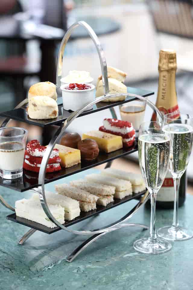 Elegant high tea setup with tiered delicacies for corporate events in Browns Mayfair.