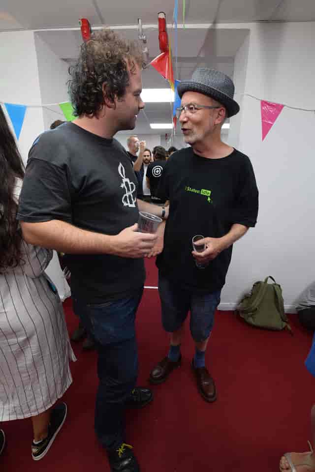 "Attendees networking at Space4 event with festive decorations, fostering collaboration."
