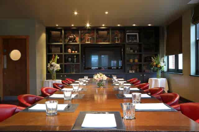Private dining room with elegant table settings for executive meetings at Beaufort House Chelsea.