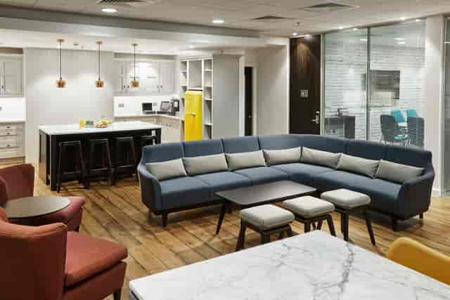 Modern break room in Marlin Waterloo with cozy sectional sofa for meetings and events.