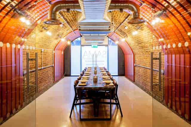 Private meeting room with exposed brick walls, ideal for workshops and team-building events.