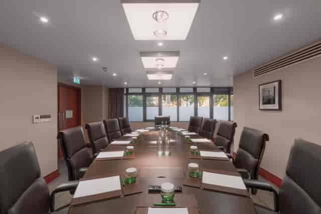 Executive Boardroom at Holiday Inn Kensington, featuring a polished table for corporate meetings.