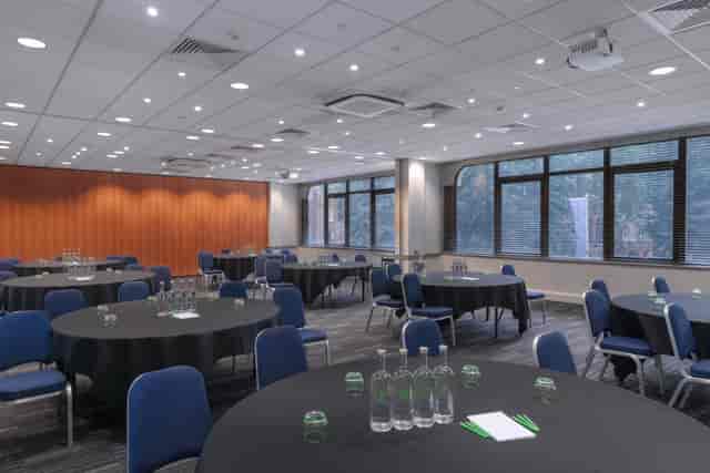 Versatile meeting space with round tables for workshops and seminars in London.