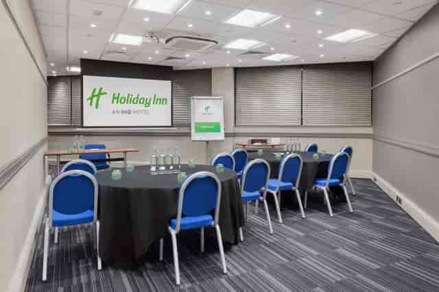 Meeting room at Holiday Inn Kensington, round tables set for corporate events.