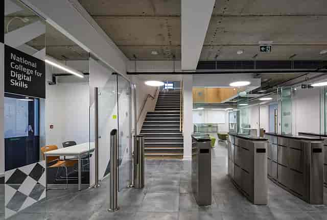 Modern meeting room with glass partitions at Ada National College for events and workshops.