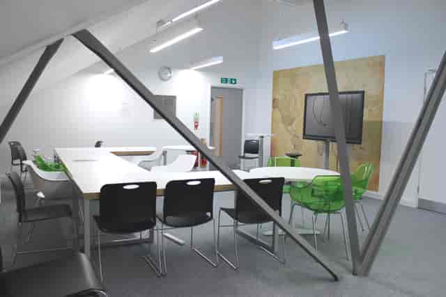Modern meeting space with large table and ergonomic chairs at Ada National College.