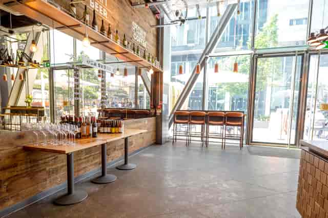 Modern event space in Notes Victoria with stylish bar, ideal for receptions and gatherings.