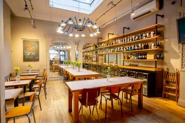 Versatile event space in Trafalgar Square with wooden tables and natural light.