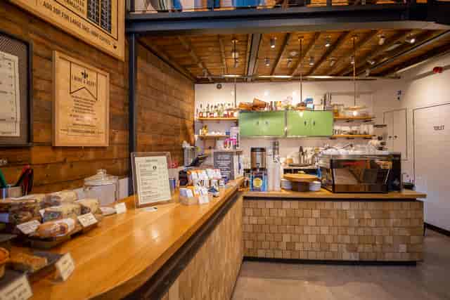 Cozy café venue with warm wood accents for networking events and informal meetings.