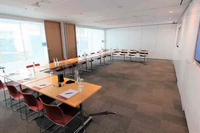 Modern Belgrave Suite meeting room with U-shaped tables for professional events.