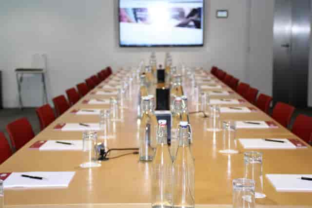 Bastwick Suite conference room with long table, notepads, and multimedia setup for meetings.