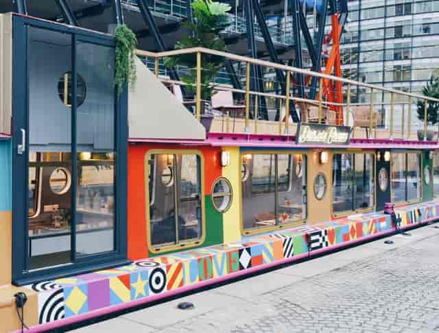 Vibrant MAY GREEN barge venue for cocktails and craft beers, ideal for events.