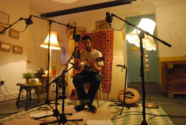 Cozy music venue with warm lighting, ideal for acoustic performances and storytelling events.