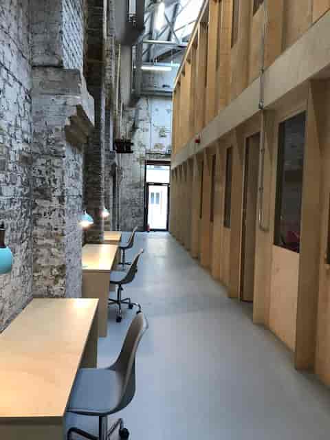 Spacious Exhibition Hall at Craft Central with exposed brick, ideal for workshops and meetings.