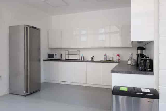 Multipurpose meeting room kitchen with sleek design for events and catering.