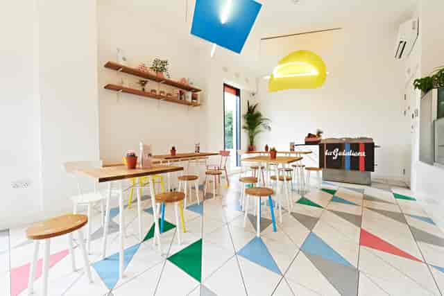 Modern gelato cafe with vibrant decor, ideal for workshops and networking events.
