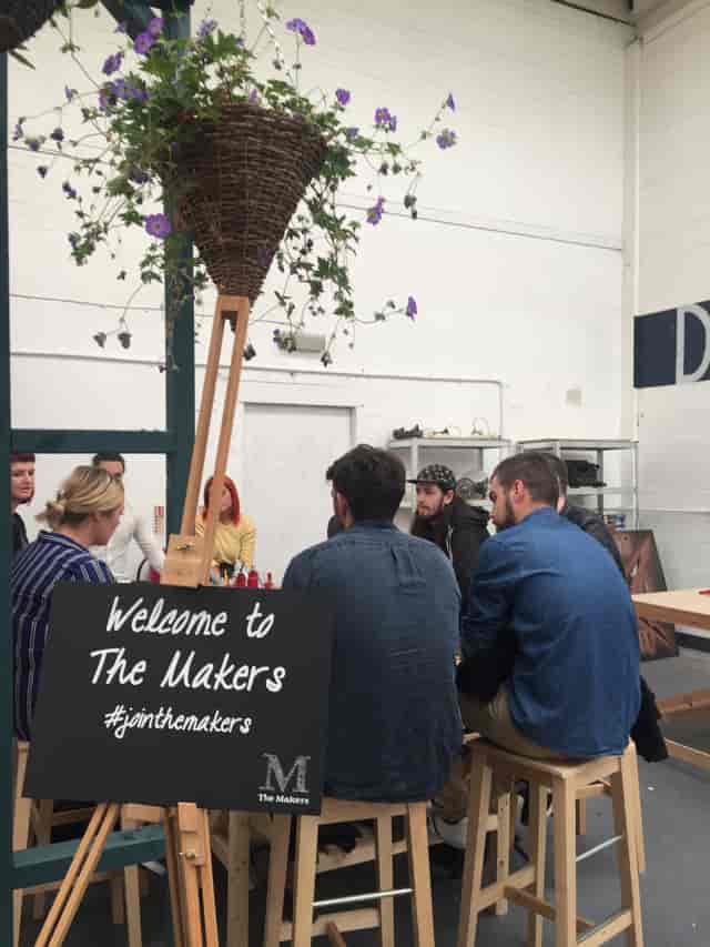 Creative workshop at The Craftyard with participants discussing around a central table.