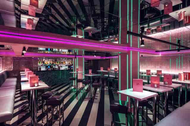 Modern event venue with bold lighting, ideal for networking and cocktail receptions.