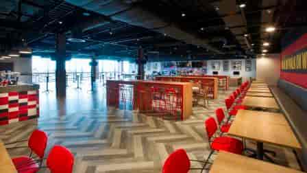 Anfield Beat event space with vibrant red seating, perfect for networking and gatherings.
