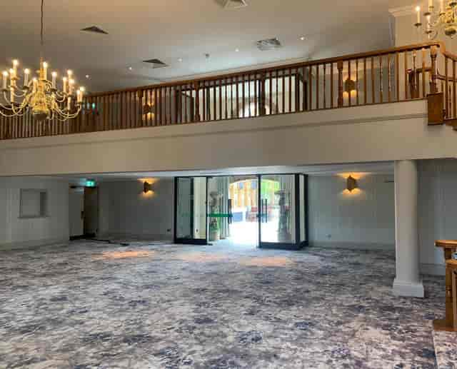 Elegant Garden Court venue with chandelier, ideal for corporate events and celebrations.