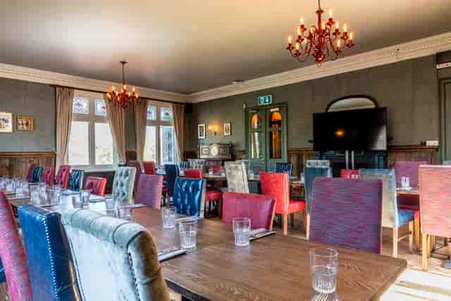 Stylish Trinity Room with colorful chairs, ideal for workshops and corporate meetings.