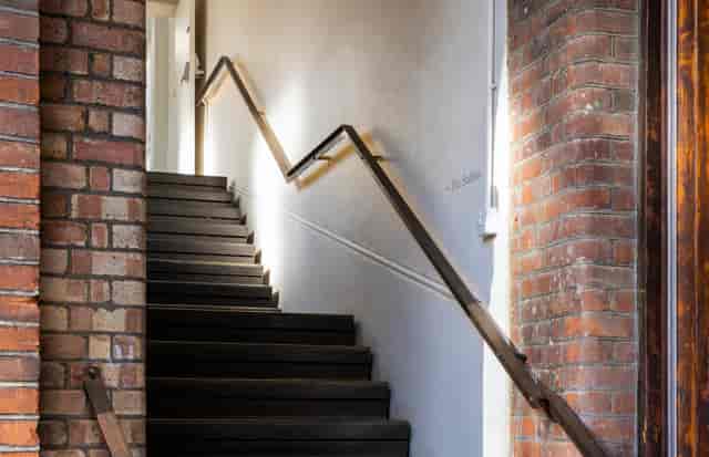 Well-lit staircase at The Stables, Park Village; ideal for events and meetings.