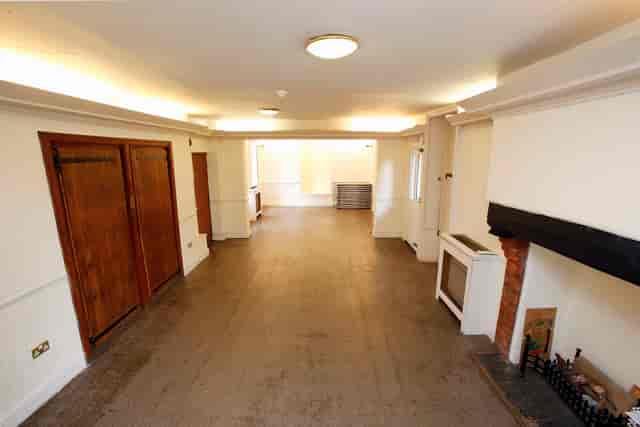 Ground Floor Salisbury Room: versatile event space with natural light and cozy fireplace.