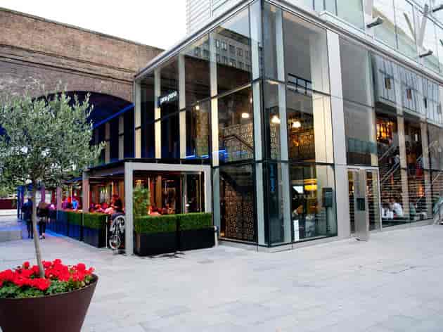 Modern event venue with glass exterior and outdoor seating in Southbank.