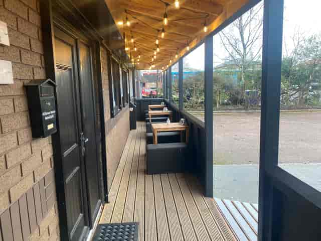 Charming outdoor venue with warm lighting for casual meetings and networking events.