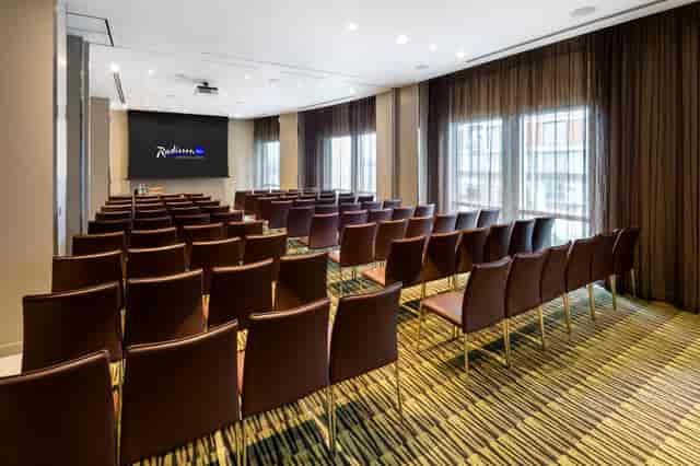 Private meeting room with brown chairs, ideal for corporate events and workshops.