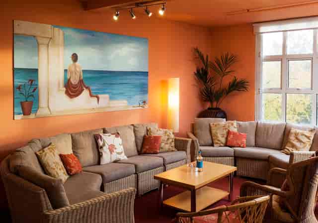 Art Studio lounge with orange seating, ideal for intimate networking and creative events.